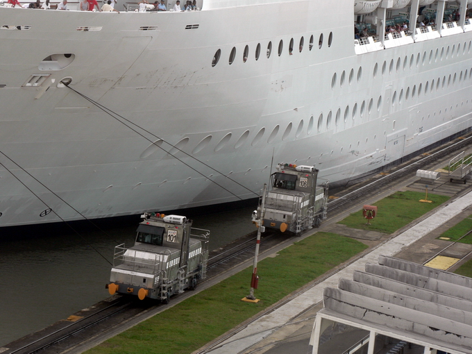Mechanized Panama Canal 'mules' pull ship through locks